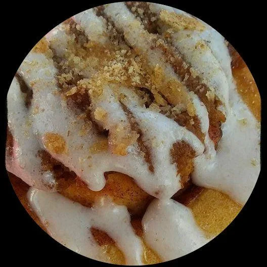 A Smackadoodles cinnamon roll with cream cheese frosting