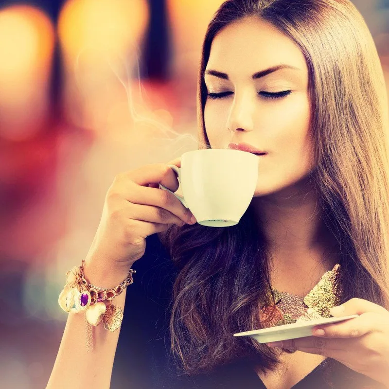 Woman sipping a cup of coffee
